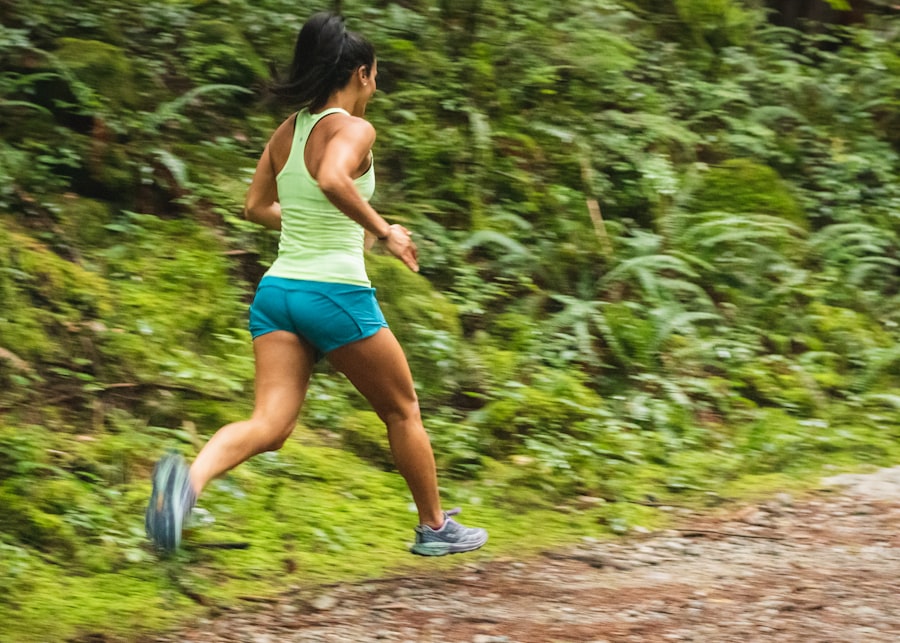 Woman running up a forest trail