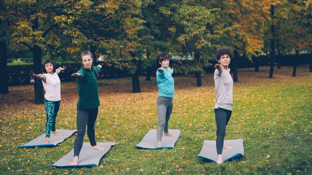 Group of women practicing yoga together in a park